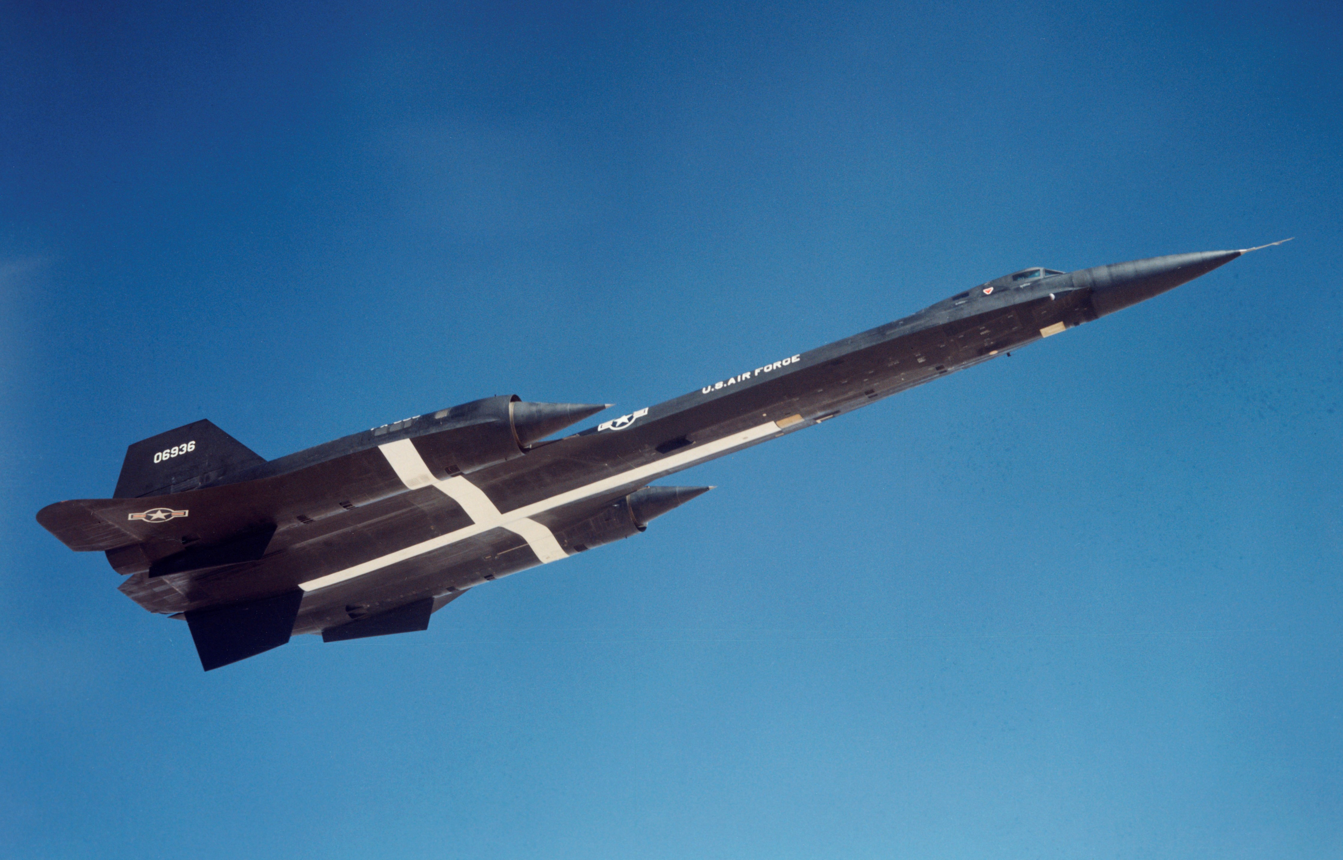 The third YF-12a departs Edwards AFB in 1965. The white cross painted on the lower fuselage assisted in tracking the aircraft during the speed and altitude record flights. (Lockheed photo) 